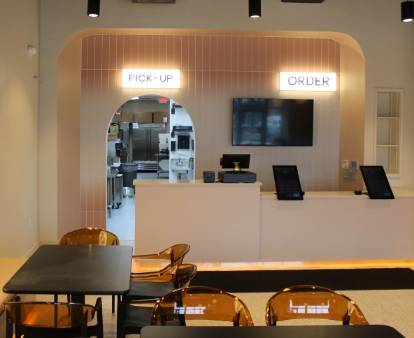 Modern restaurant interior with order and pick-up counter showcasing professional restaurant build-out and commercial construction in Columbus, Ohio.
